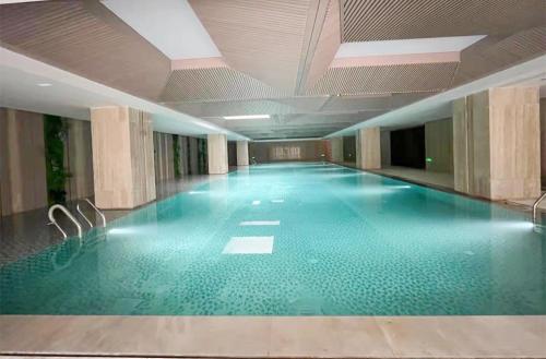 a large swimming pool in a large building at The Qube Hotel Anqing in Anqing