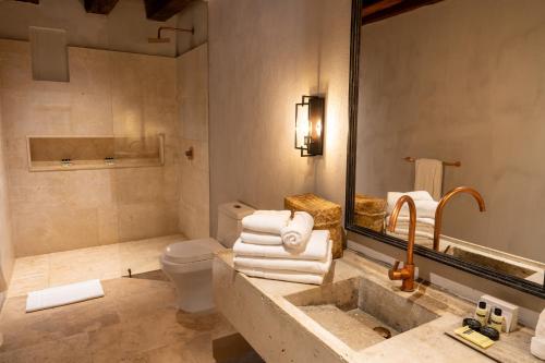 a bathroom with a sink and a toilet and a mirror at Hotel Casa Don Luis by Faranda Boutique, a member of Radisson Individuals in Cartagena de Indias