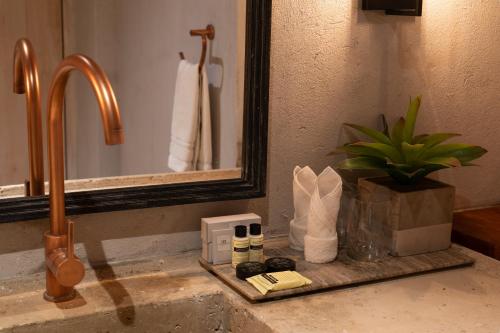 a bathroom sink with a faucet and a mirror at Hotel Casa Don Luis by Faranda Boutique, a member of Radisson Individuals in Cartagena de Indias