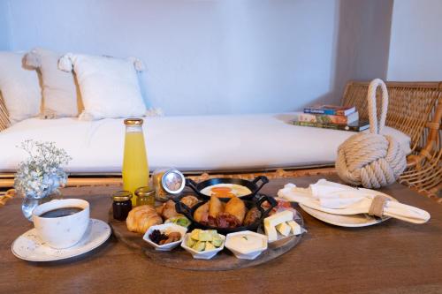 a tray of food on a table next to a bed at Hotel Casa Don Luis by Faranda Boutique, a member of Radisson Individuals in Cartagena de Indias