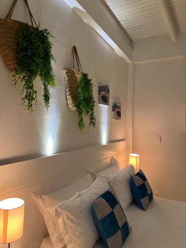 a bedroom with a bed with plants on the wall at La Excelencia Posada & Spa in San Cristóbal