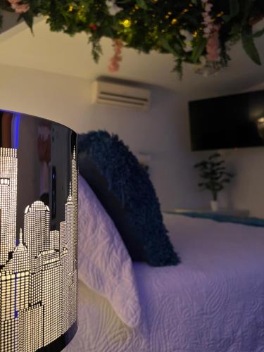 a bedroom with a bed with purple sheets and a city at La Excelencia Posada & Spa in San Cristóbal