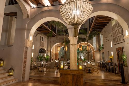 a large room with tables and chairs and a large chandelier at Hotel Casa Don Luis by Faranda Boutique, a member of Radisson Individuals in Cartagena de Indias
