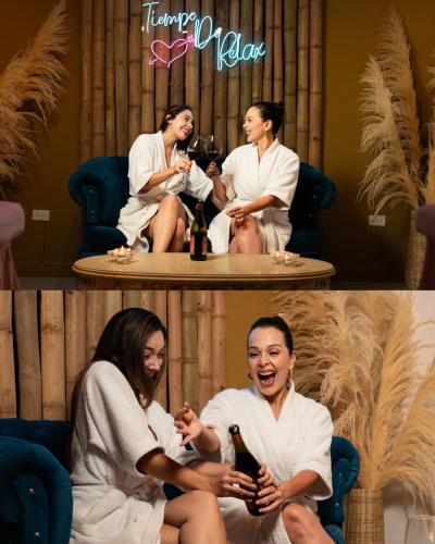 a group of people sitting around a table with wine bottles at La Excelencia Posada & Spa in San Cristóbal
