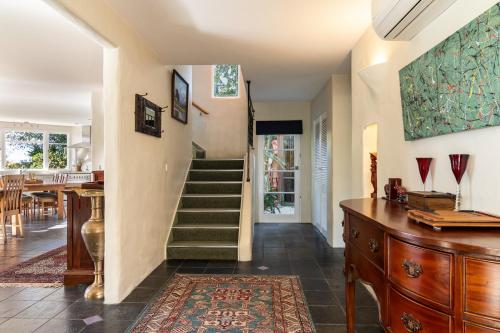 a living room with a staircase and a table at Camelot Island Retreat in Appleby