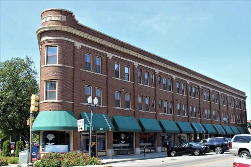 a large brick building on a street with cars parked outside at Corner view close to Gainsbridge and Lucas Oil in Indianapolis