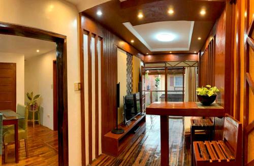 a living room with a table and a television at Tagum Mini Hotel By Tripleview residences in Tagum