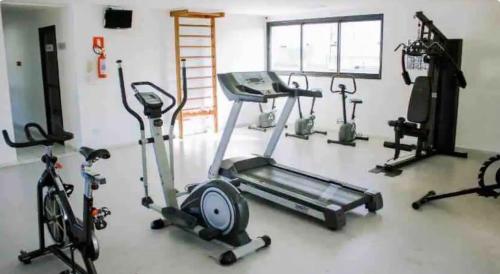 a gym with several exercise bikes and a treadmill at TENHA uma BELA VISTA DO MAR de Pajuçara NEO 2 qts 2garar - Adm Nutelss in Maceió