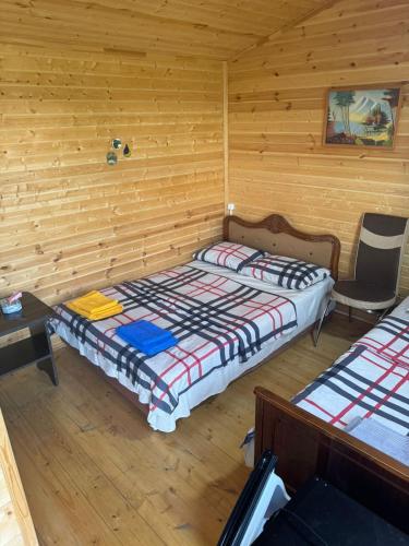 a bedroom with two beds and a table and a chair at Eco Aura (RestZone) in Areguni
