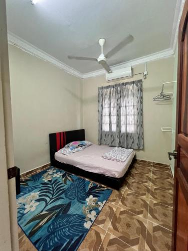 a small room with a bed and a window at Homestay Ayah Ngah Marang in Marang