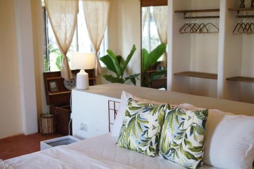 a bedroom with a bed with a pillow on it at The Shore Koh Chang Boutique Resort in Ko Chang