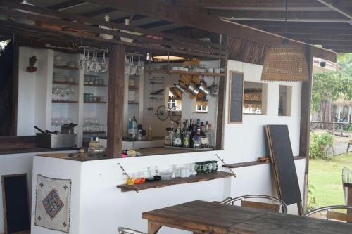 a bar in a restaurant with a table and chairs at The Shore Koh Chang Boutique Resort in Ko Chang
