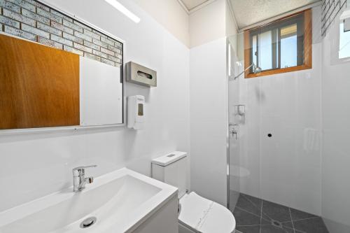 a white bathroom with a sink and a toilet at Comfort Inn Benalla in Benalla