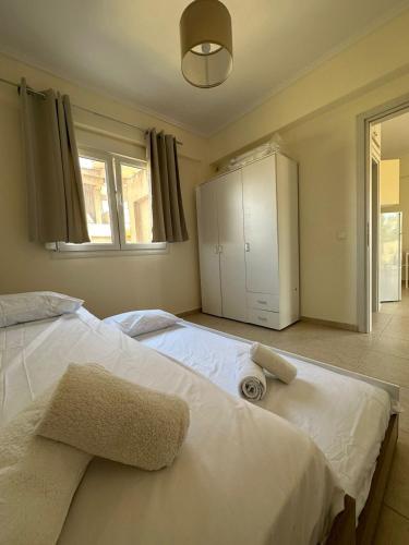 a bedroom with a large bed with towels on it at Dimar3 Seaside Apartment in Paralia Dionysiou
