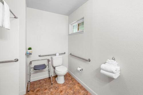 a bathroom with a white toilet and towels at Quality Inn & Suites in Jackson