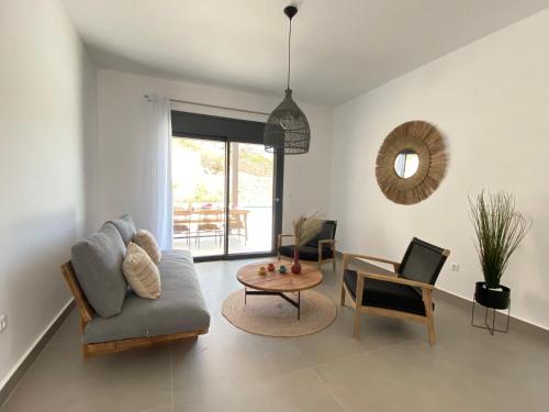 a living room with a couch and a table at Pefkos Vista Luxury Villas in Pefki Rhodes