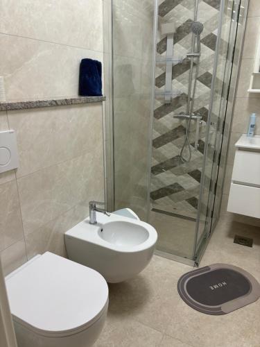 a bathroom with a shower and a toilet and a sink at Lazar ONE Aparment in Izola