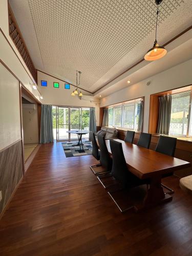 a conference room with a wooden table and chairs at Sunrise Vista Nanjyo -SEVEN Hotels and Resort- in Nanjo