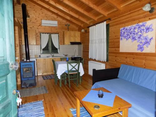 a living room with a couch and a stove at Alagonia Country Homes in Alagonía