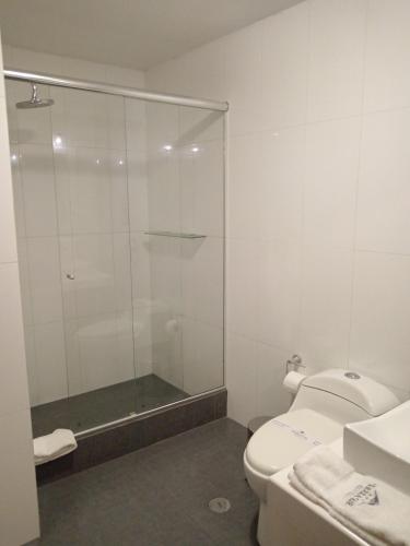 a bathroom with a glass shower and a toilet at Hotel Tierrasur in Arequipa