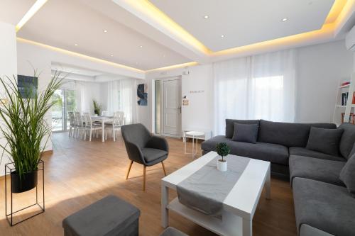 a living room with a couch and a table at Villa Dana in Ixia