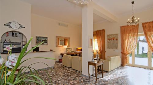 a living room with a couch and a table at Hotel Verdesolemare in Marina di Pietrasanta