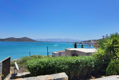 a view of the ocean with people standing on a building at Andromeda Sea View Villa in Epáno Eloúnda