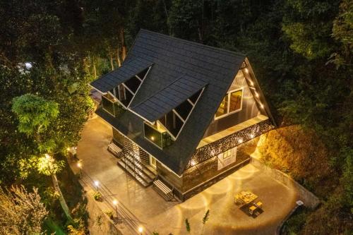 an overhead view of a house in the woods at night at The Cove Lakkidi in Vythiri