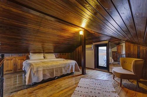a bedroom with a bed and a wooden ceiling at Alayaz Hotel in Alacati