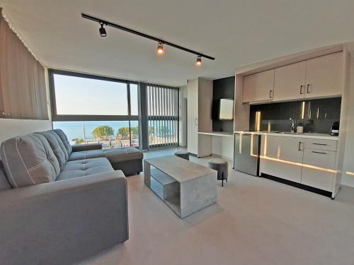 a living room with a couch and a table at Casa Del Sol Luxury House in Xylokastron