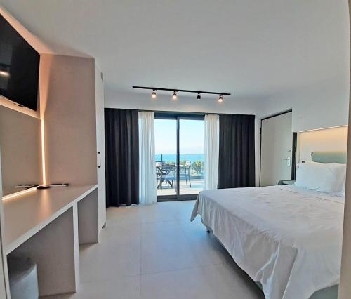 a bedroom with a bed and a view of the ocean at Casa Del Sol Luxury House in Xylokastron