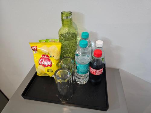 a black tray with bottles and glasses on a table at Deer Park Home Stay in New Delhi