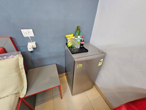 a small refrigerator in a corner of a room at Deer Park Home Stay in New Delhi