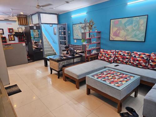 a room with a couch and a table with a giant chessboard at Deer Park Home Stay in New Delhi
