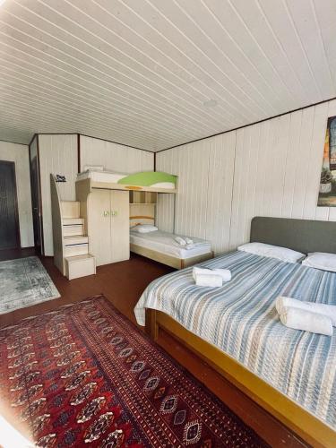 a bedroom with a large bed and a rug at Hotel Galushko in Mykulychyn