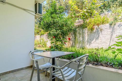 a table and two chairs sitting on a patio at Aphrodite's Garden in Himare