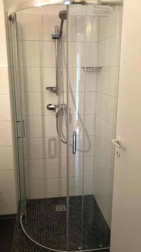 a shower with a glass door in a bathroom at Rheinliebe Bistro und Pension in Lorch am Rhein