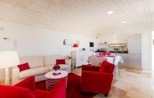 a living room with a white couch and red chairs at 2 Bedroom Cozy Home In Ostuni in Ostuni