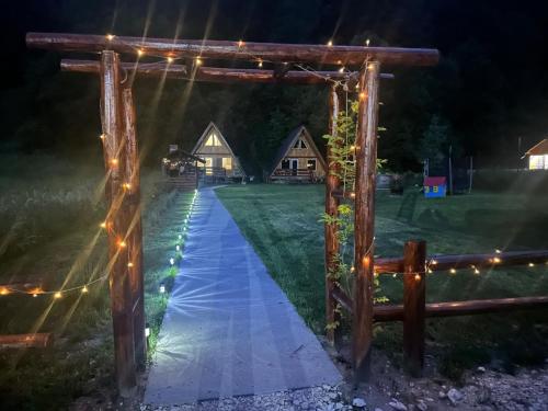 a pathway leading to a cabin at night with lights at Cabanutze Satic in Rucăr