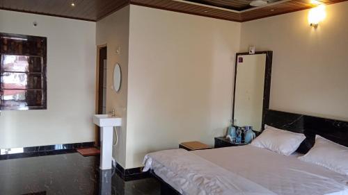 a bedroom with a white bed and a window at NAVARATHNA International resort in Sollebail