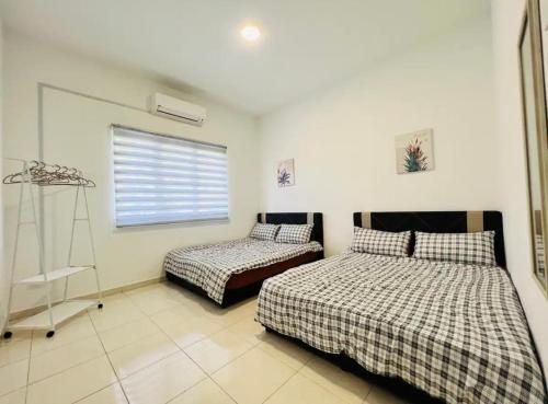 a bedroom with two beds and a window at MoonLight Sweet Home Kuala Selangor 30pax karaoke in Kuala Selangor