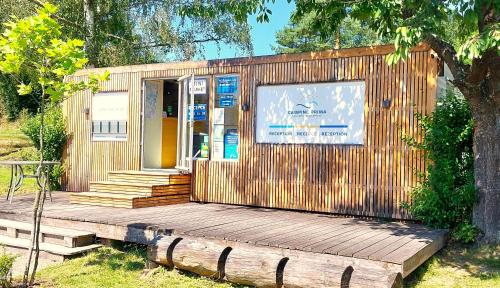 a small building with a wooden porch and stairs at Camping Prima in Týn nad Vltavou