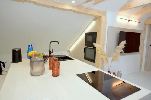 a kitchen with a white counter top with a sink at Apartamenty Blanca in Łeba
