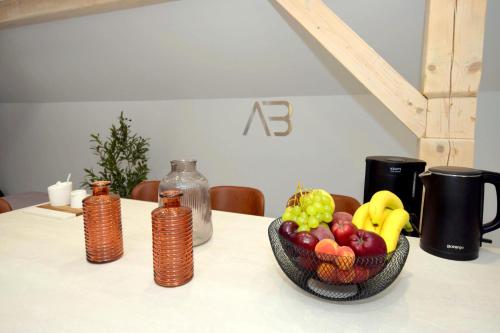 a bowl of fruit sitting on top of a table at Apartamenty Blanca in Łeba