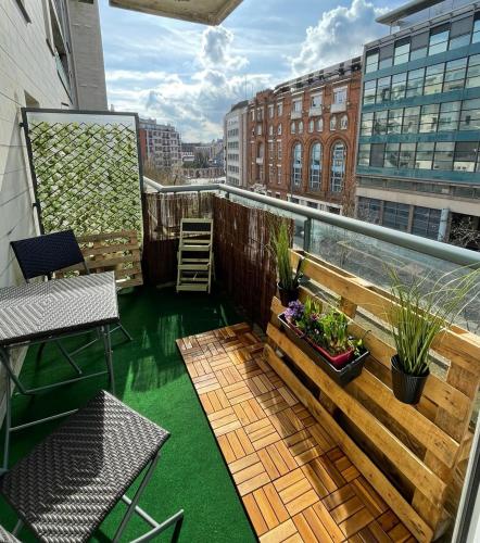 a balcony with green flooring on a building at Green Balcony Lille Hyper centre in Lille