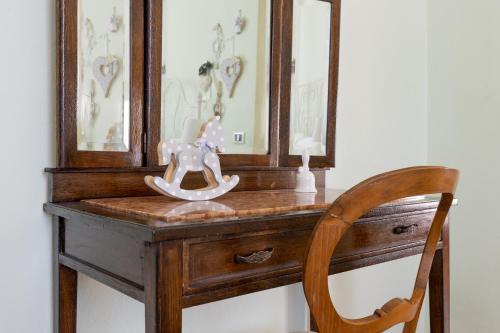 a wooden dresser with a rocking horse on top of it at B&B Il Ramaiolo in Santa Maria a Monte
