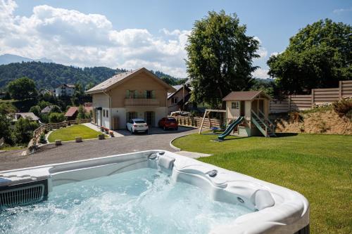 a hot tub in the yard of a house at Eny Guesthouse in Moieciu de Jos