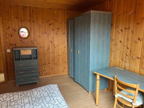 AumontにあるAuberge du rendez vousの机とキャビネットのある木造の部屋