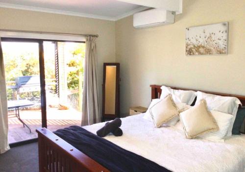 Un dormitorio con una cama con un osito de peluche encima. en Break O'Day View - Flowerdale, en Glenburn