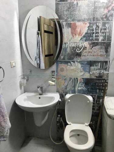 a bathroom with a sink and a toilet and a mirror at Porto Sokhna Heaven Hills Chalet Families ONLY in Ain Sokhna